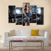 Muscular bodybuilder guy doing exercises with big dumbbell in gym, Multi panel canvas wall art