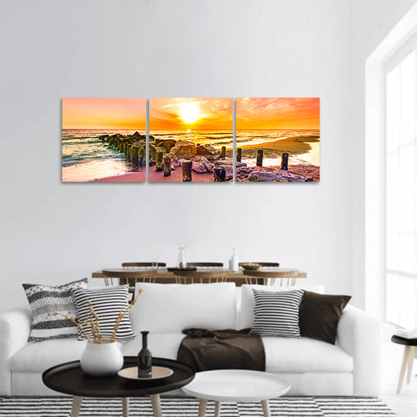 Colourful sunset on a beach panoramic canvas wall art
