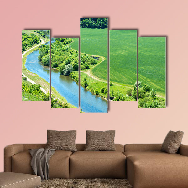 Landscape of river, green wheat field with nearby forest wall art