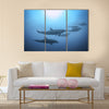 Row of beautiful dolphins swimming view under the water in the ocean multi panel canvas wall art