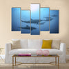 Row of beautiful dolphins swimming view under the water in the ocean multi panel canvas wall art