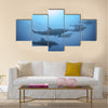 Row of beautiful dolphins swimming view under the water in the ocean multi panel canvas wall art