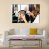 Professional Hairdresser is Making a Haircut with Scissors and a Comb for a Male Customer Multi Panel Canvas Wall Art