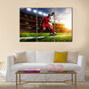 Soccer players in action on sunset stadium background panorama Multi Panel Canvas Art