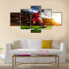 Soccer players in action on sunset stadium background panorama Multi Panel Canvas Art