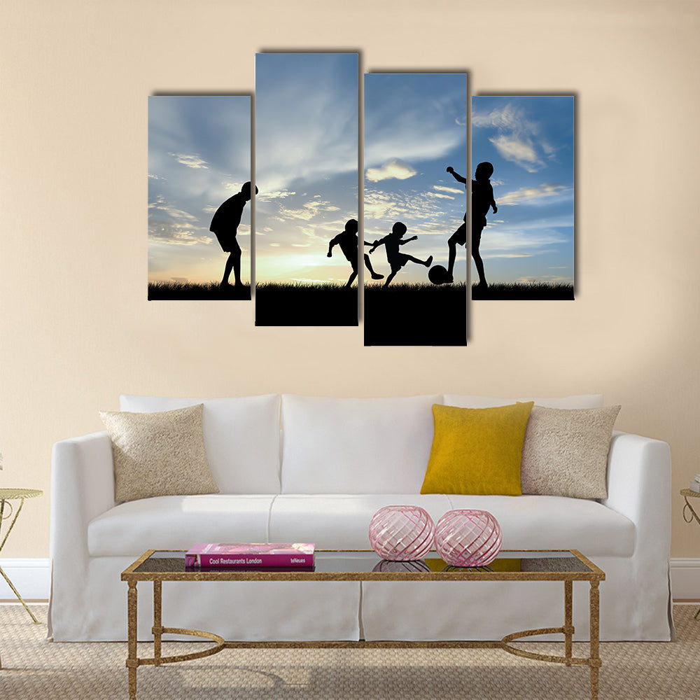 Silhouette boys playing football at sunset Multi panel canvas wall art