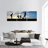 Silhouette boys playing football at sunset Panoramic Canvas Wall Art