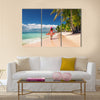 Carefree, Young woman relaxing on the Islands beach Multi Panel Canvas Wall Art