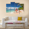 Carefree, Young woman relaxing on the Islands beach Multi Panel Canvas Wall Art