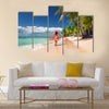 Carefree, Young woman relaxing on the Islands beach Multi Panel Canvas Wall Art