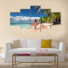 Carefree, Young woman relaxing on the Islands beach Multi Panel Canvas Wall Art