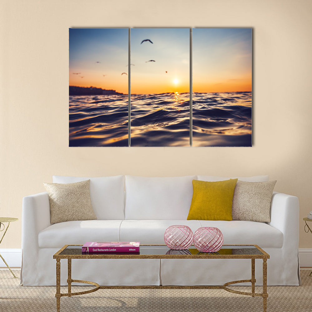 Sunrise light shining on ocean wave Multi Panel Canvas Wall Art