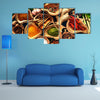 Various herbs and spices on wooden table Multi panel canvas wall art