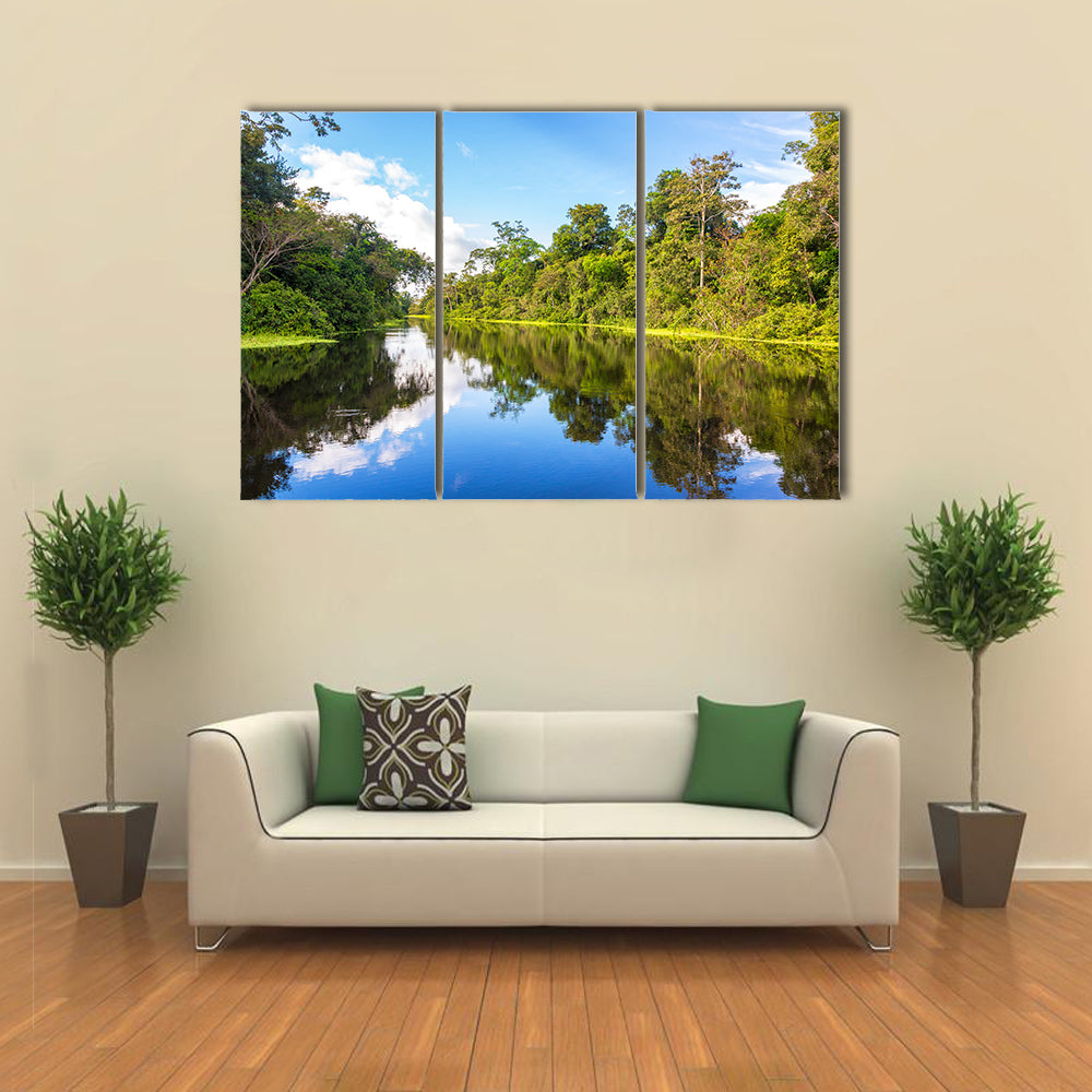 Amazon rain forest perfectly reflected in a small river near Iquitos, Peru multi panel canvas wall art