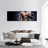 Handsome young man in shorts, doing exercises for biceps Panoramic Canvas Wall Art