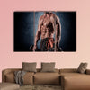 Young handsome sporty man doing exercise with dumbbells Multi panel canvas wall art