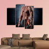 Young handsome sporty man doing exercise with dumbbells Multi panel canvas wall art