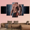 Young handsome sporty man doing exercise with dumbbells Multi panel canvas wall art