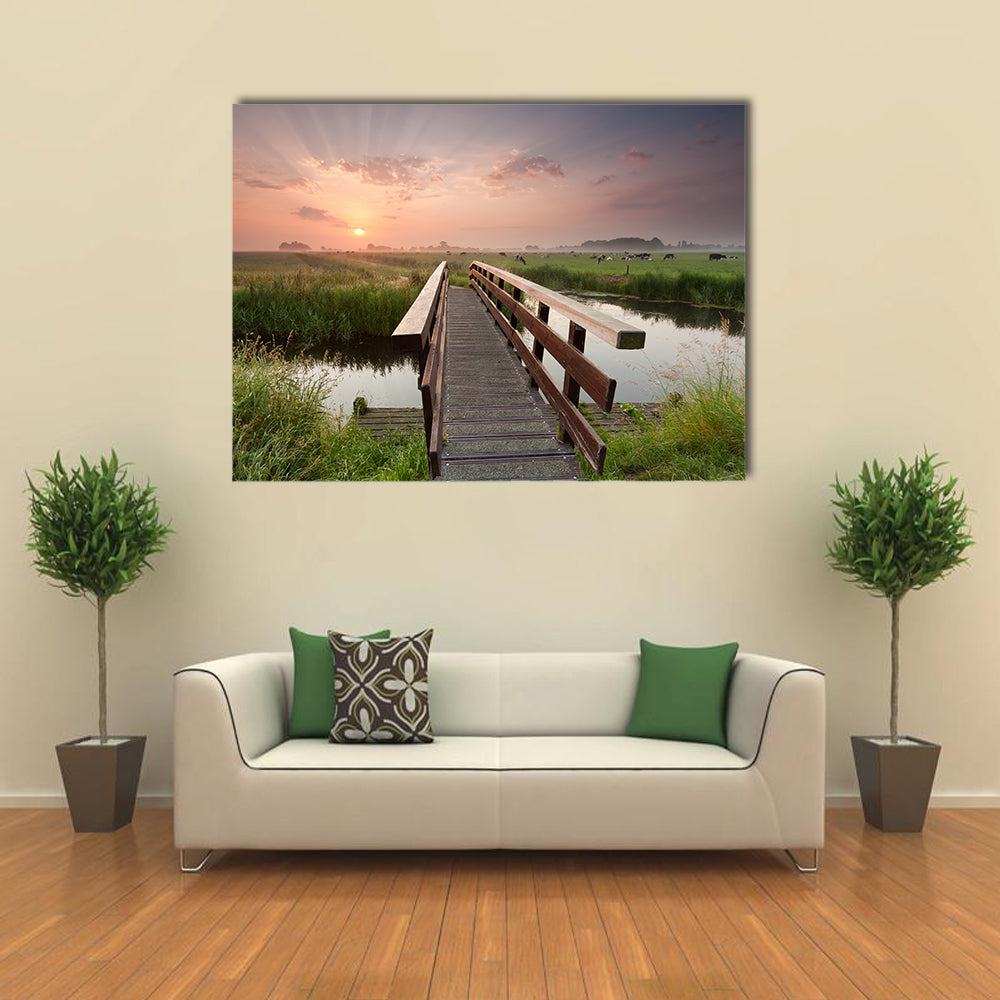 beautiful sunrise over bike bridge in farmland, Netherlands multi panel canvas wall art