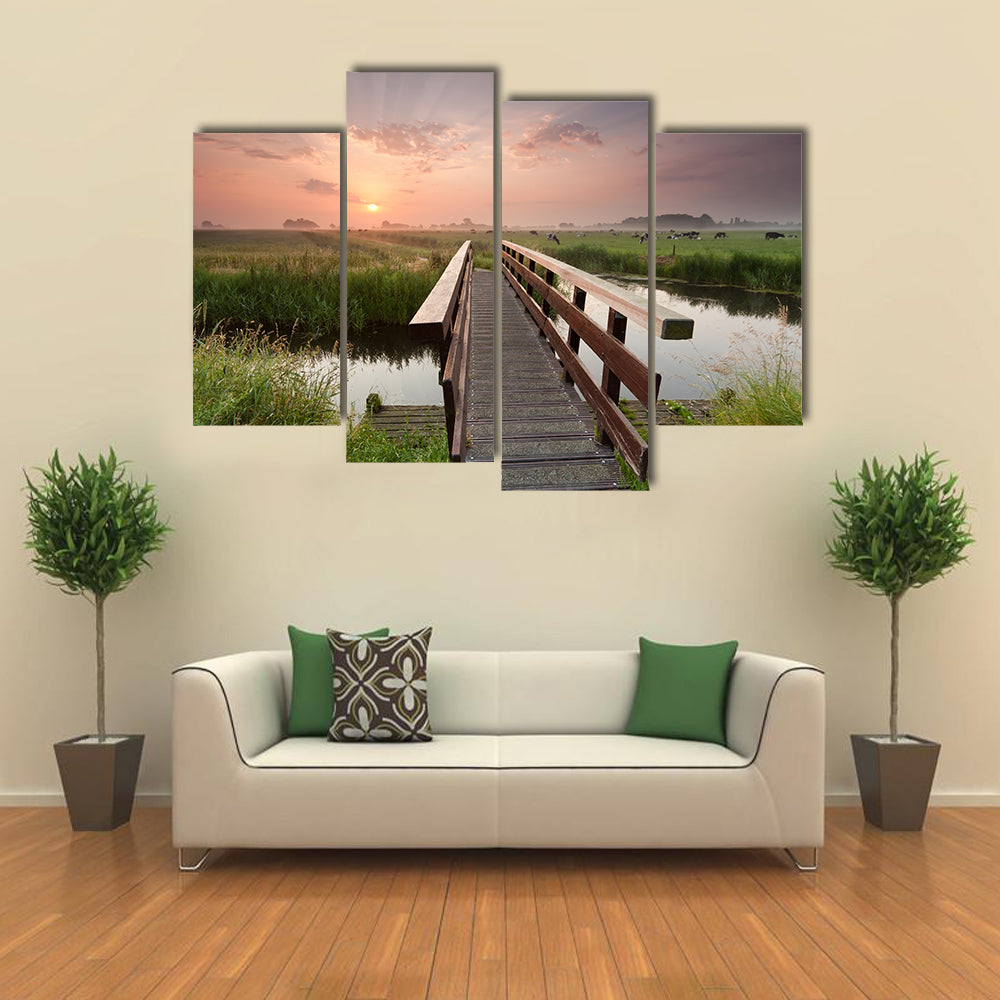 beautiful sunrise over bike bridge in farmland, Netherlands multi panel canvas wall art