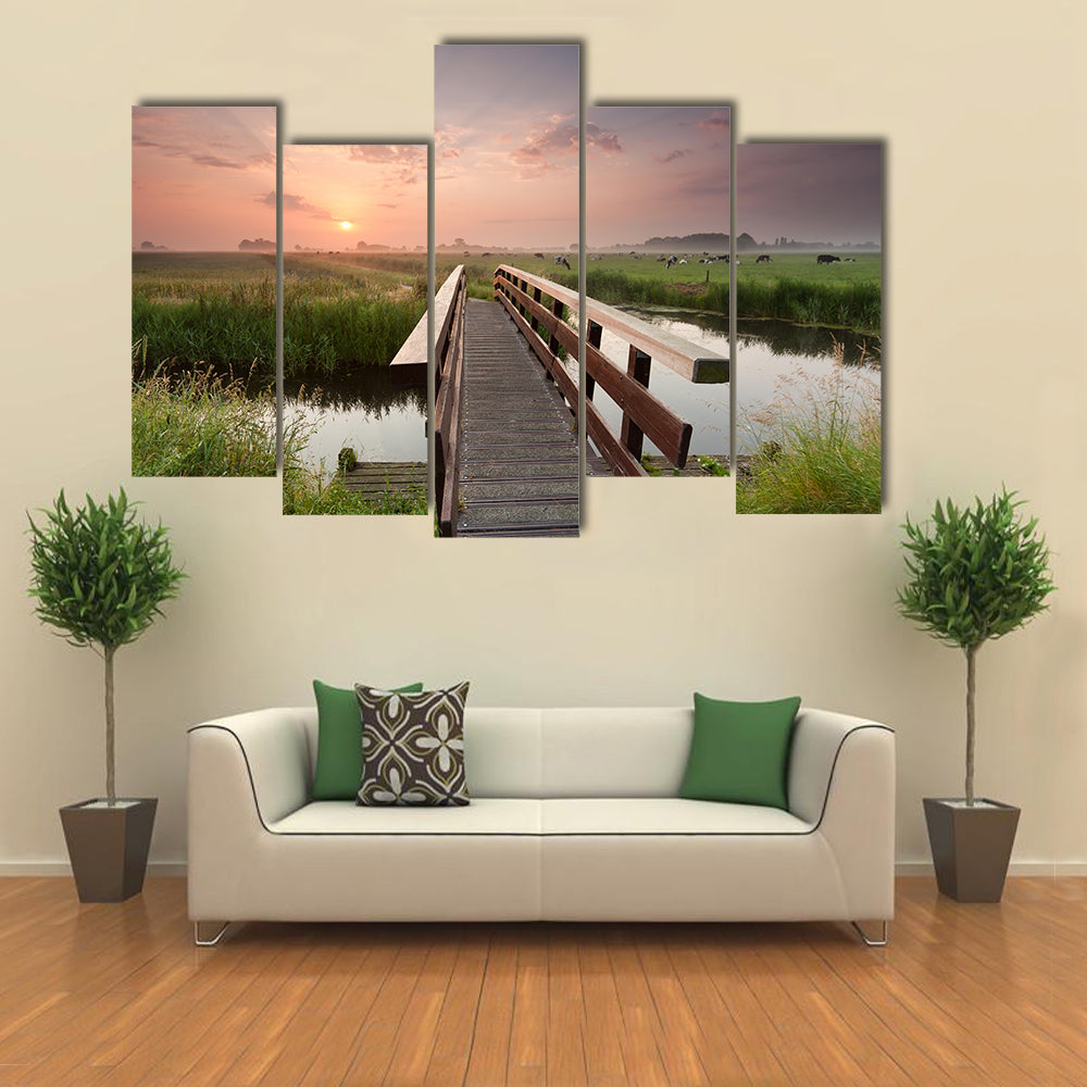 beautiful sunrise over bike bridge in farmland, Netherlands multi panel canvas wall art