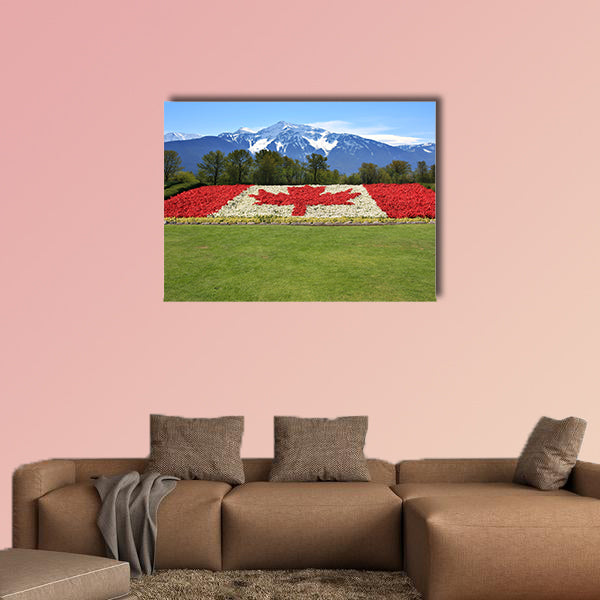 Canada flag done in red and white begonia flower against a backdrop wall art