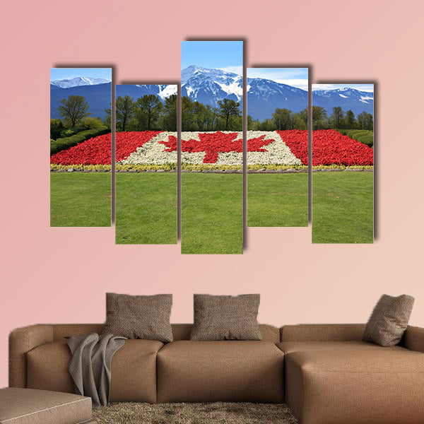 Canada flag done in red and white begonia flower against a backdrop of the rocky mountains Multi panel canvas wall art