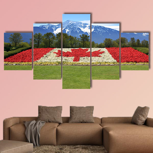 Canada flag done in red and white begonia flower against a backdrop of the rocky mountains Multi panel canvas wall art