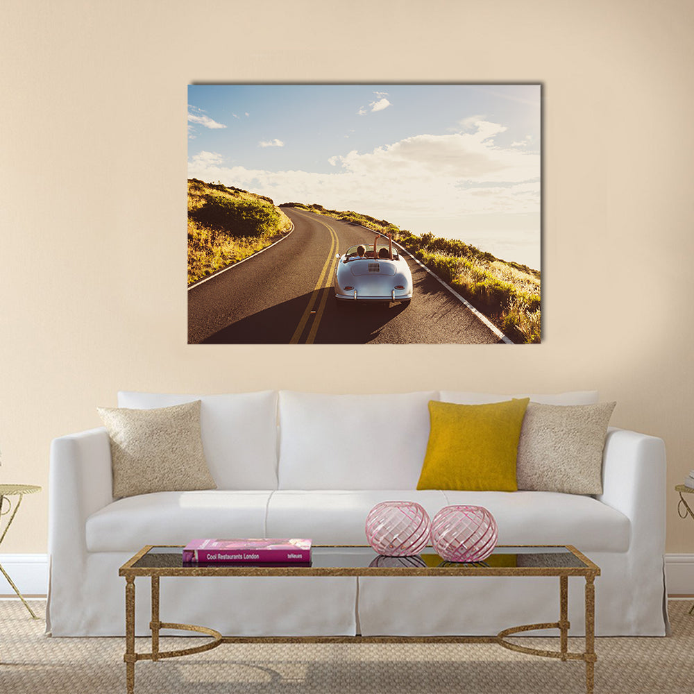 Happy Couple Driving on Country Road in Classic Vintage Sports Car Multi panel canvas wall art
