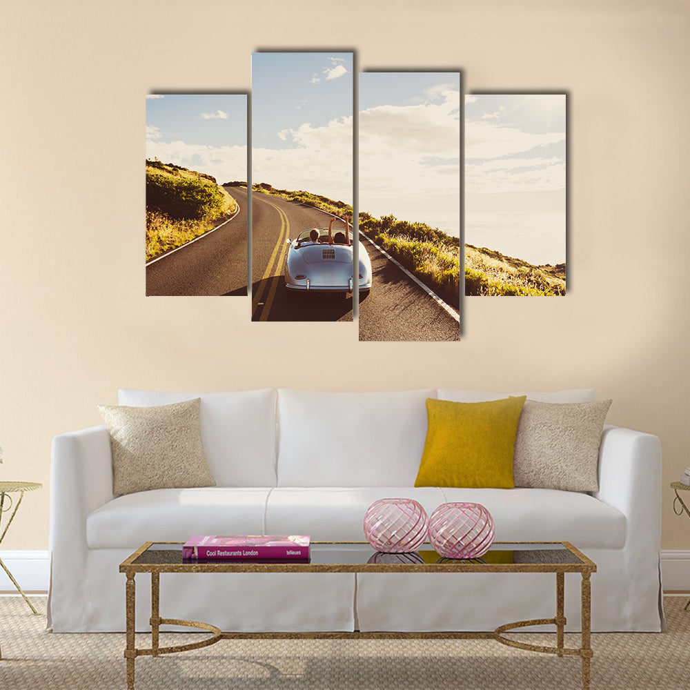 Happy Couple Driving on Country Road in Classic Vintage Sports Car Multi panel canvas wall art