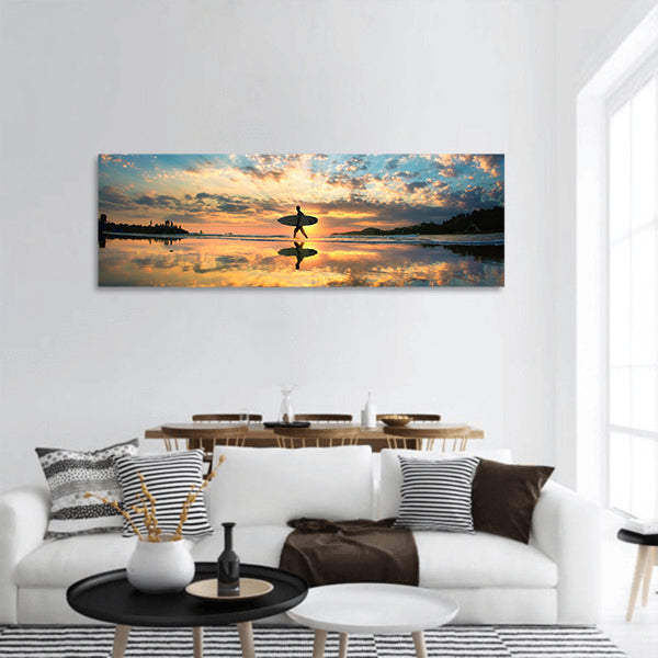 A man is walking with a surf panoramic canvas wall art