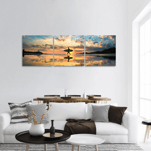 A man is walking with a surf panoramic canvas wall art