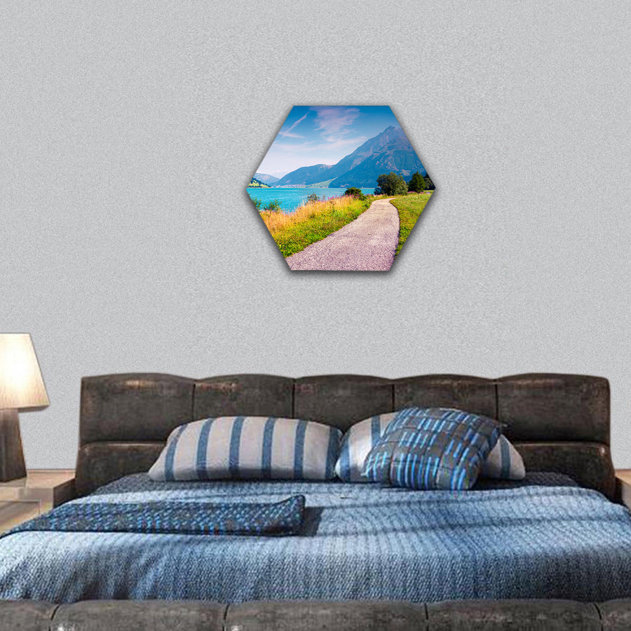 Bicycle path around Resia lake in the Italian Alps hexagonal canvas wall art