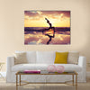 Silhouette of woman practicing yoga on the beach Multi panel canvas wall art