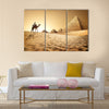 Bedouin on camel near pyramids in desert  Multi panel canvas wall art