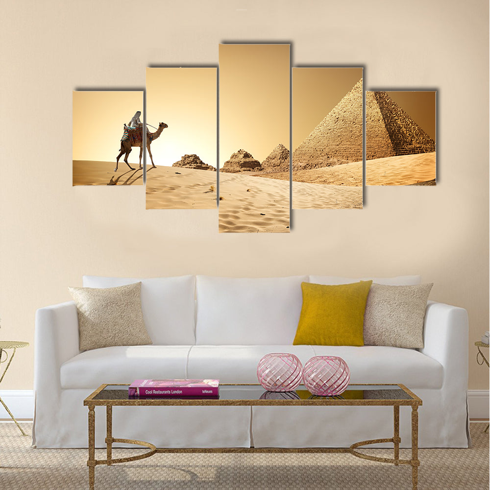 Bedouin on camel near pyramids in desert  Multi panel canvas wall art