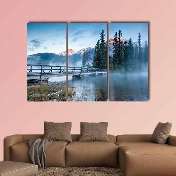 First glimpse of a golden sunrise on a misty and foggy morning multi panel canvas wall art