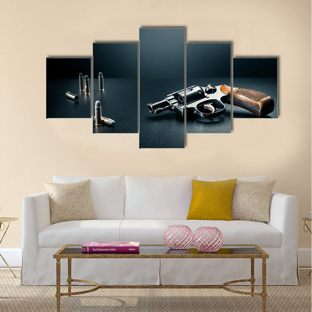 gun sitting on a table with bullet shells multi panel canvas wall art