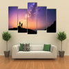 Romantic couple standing together holding hands in the mountains multi panel canvas wall art