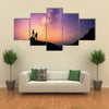 Romantic couple standing together holding hands in the mountains multi panel canvas wall art