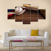 An old, antique American flag with vintage baseball equipment on a wooden bench Multi Panel Canvas Art