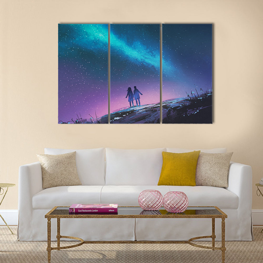 Young couple standing holding hands against the Milky Way galaxy Multi Panel Canvas Wall Art