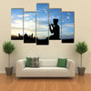 In The Evening With Cool Breeze A Silhouette Muslim Praying Before God Multi Panel Canvas Wall Art