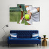 Tennis player holding racket and ball in hands Multi panel canvas wall art