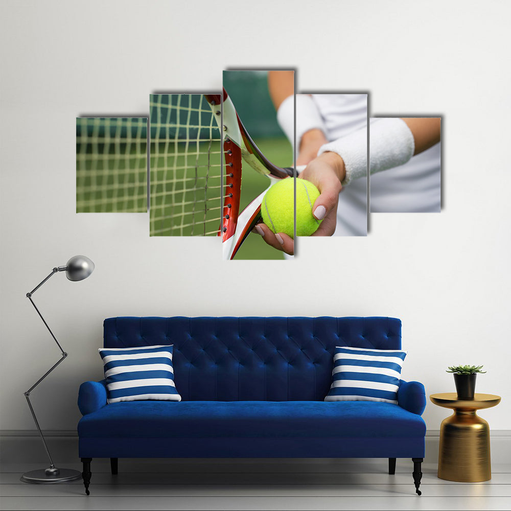 Tennis player holding racket and ball in hands Multi panel canvas wall art