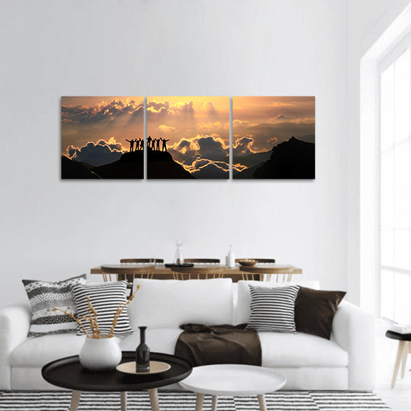 A group of people stands on a hill panoramic canvas wall art