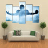 One American football player portrait in silhouette shadow on white background Multi panel canvas wall art