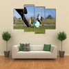 Close-up of young soccer player taking a penalty kick against a young blurred boy Multi panel canvas wall art