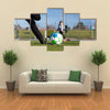 Close-up of young soccer player taking a penalty kick against a young blurred boy Multi panel canvas wall art