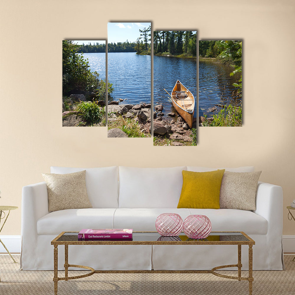 A yellow fisherman's canoe on a rocky shore of a northern Minnesota lake multi panel canvas wall art